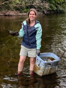 A bin full of debris and a tiny tea pot found in the Speed River