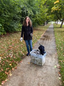 Great Lake Cleaner filling up a bin with discarded rags found in a nearby forest using gloves and grabber for safety